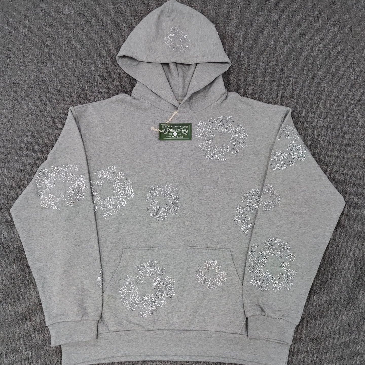 Gray hoodie with floral patterns on a gray background